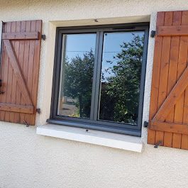 Fenêtre aluminium avec volets bois sur maison en pierre, Gers